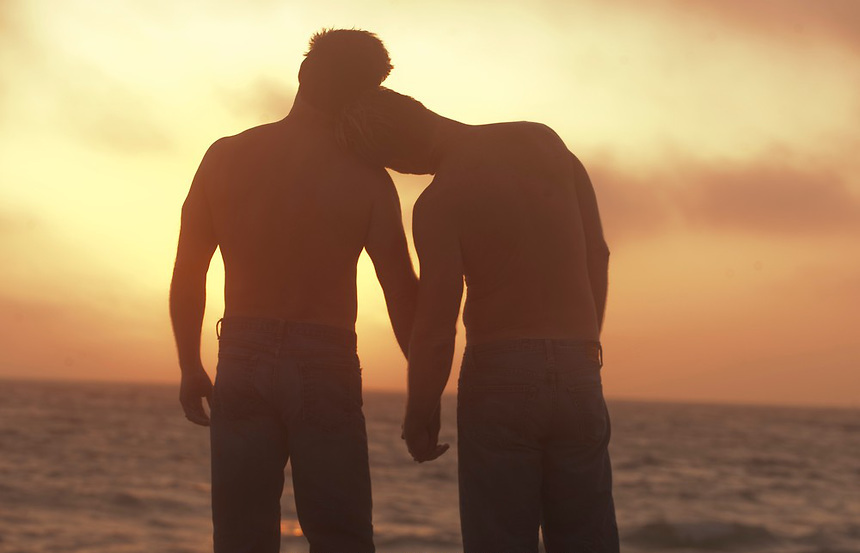 two-men-on-the-beach-at-sunset-holding-hands1.jpg